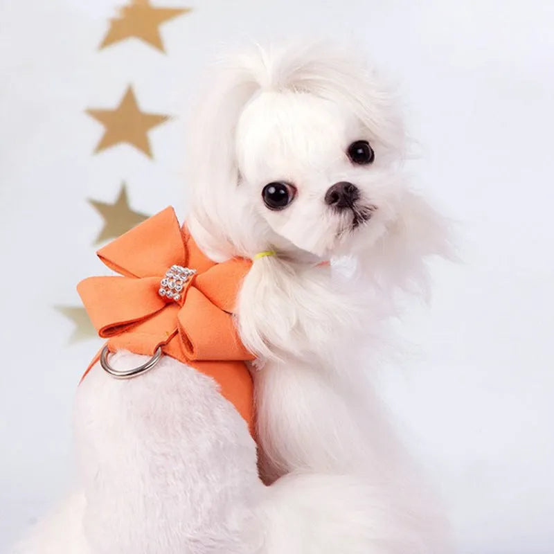 A pink microfiber dog harness with a decorative bowknot on the collar, sized for a small puppy.