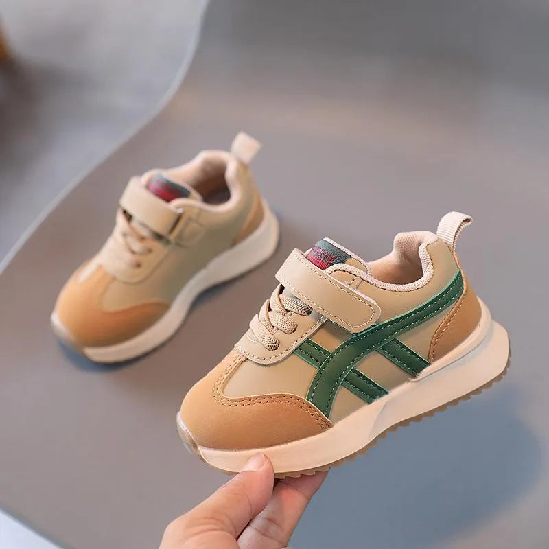 Children's white casual sneaker with Velcro strap and rubber sole, shown in sizes 21-30.