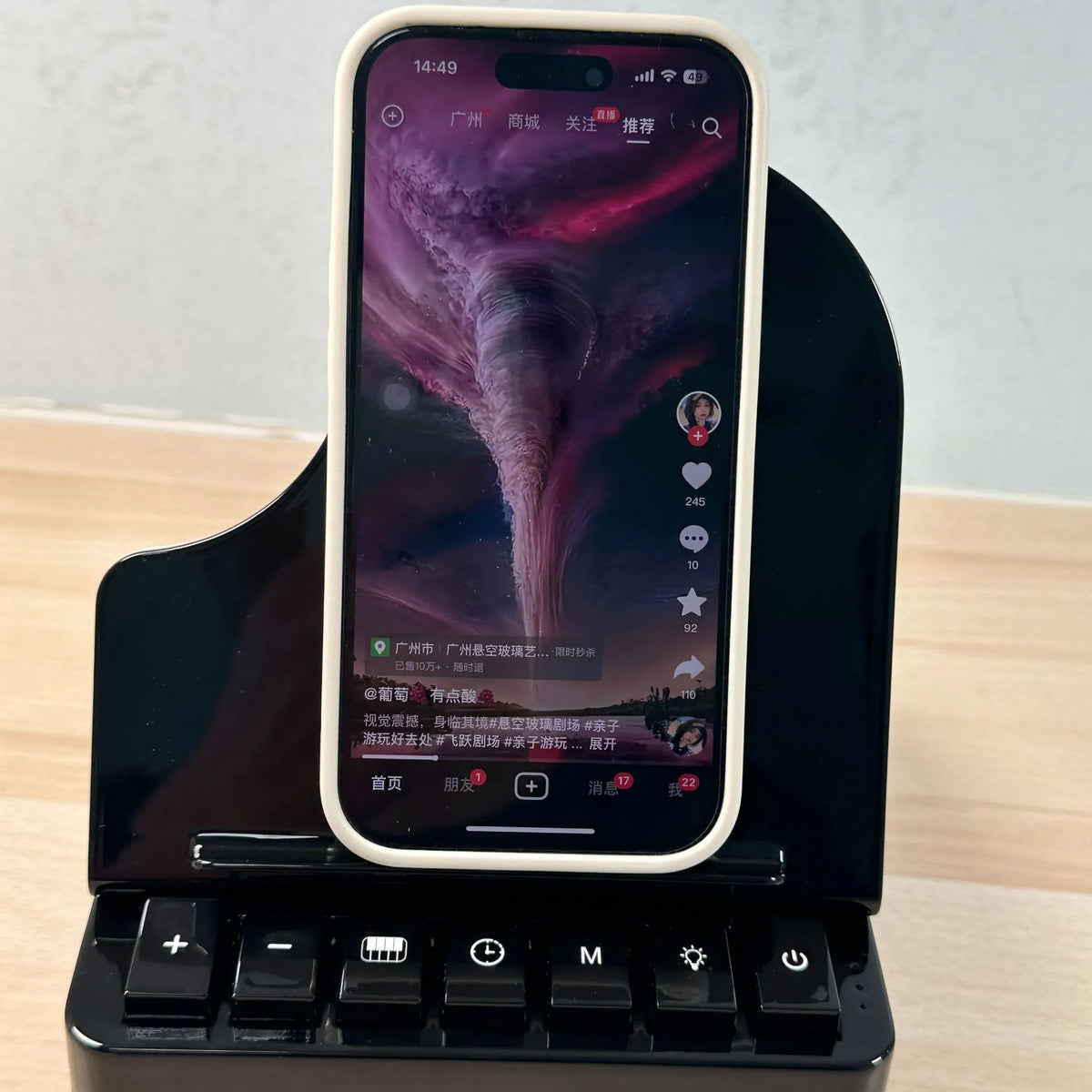 Black multi-function Bluetooth speaker with wireless charger and phone holder showing LED lighting