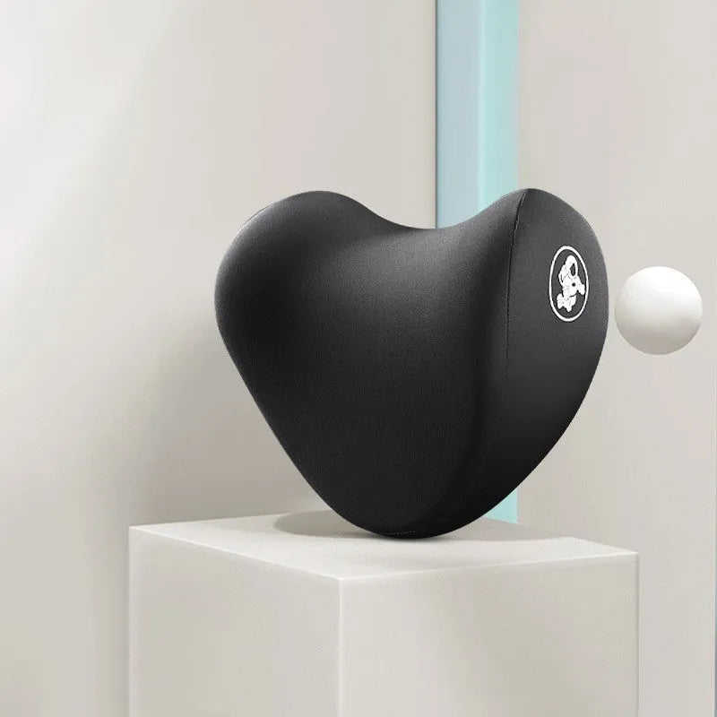 Heart-shaped car pillow in choice of colours, shown as headrest and lumbar support on a car seat.