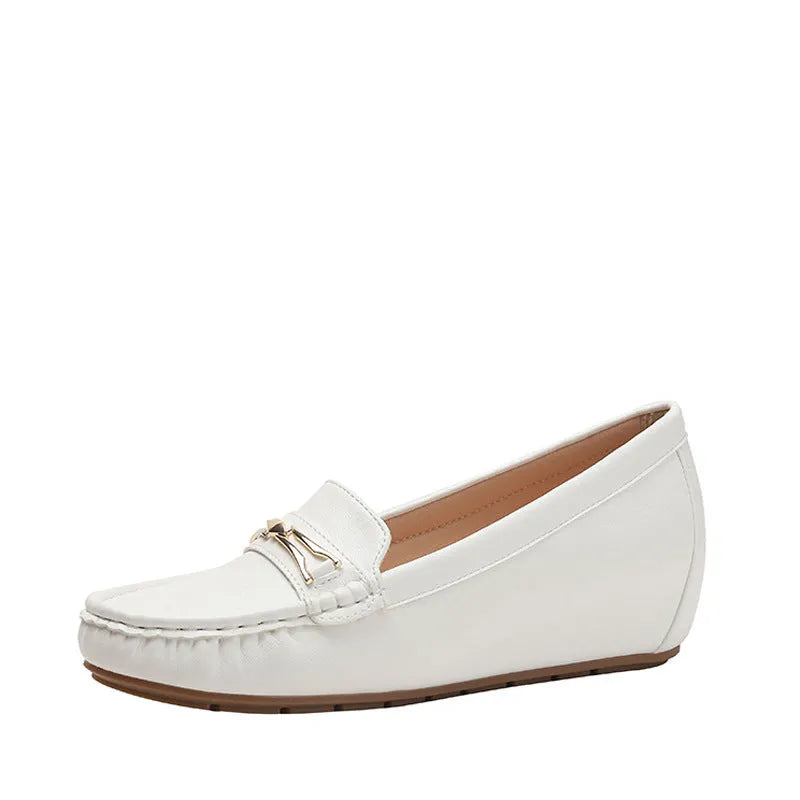 Black, white, and brown slip-on shoes with a round toe and a soft rubber sole for height increase
