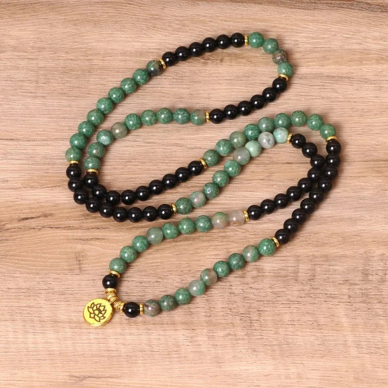 Green and black alloy elastic beaded long bracelet on a wrist, showing natural style design.