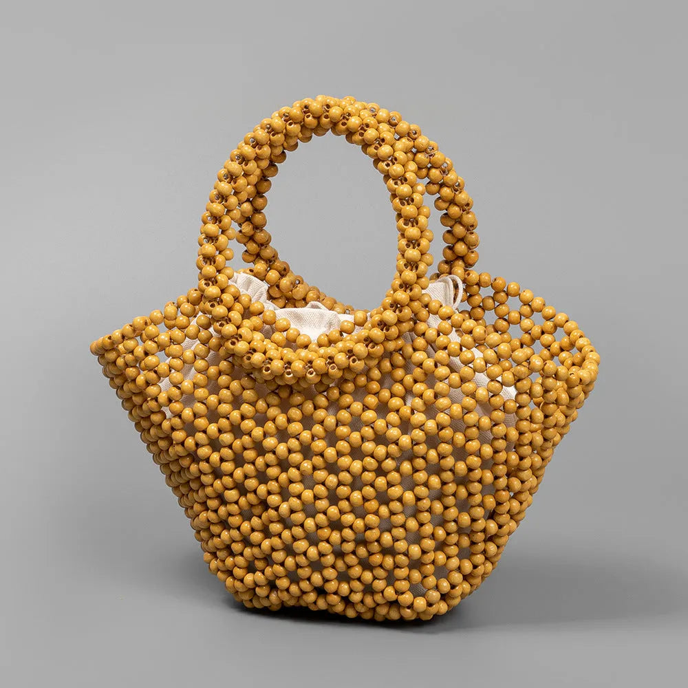 Hand-woven dumpling-shaped maple beach handbag with wooden bead decoration in milky white colour