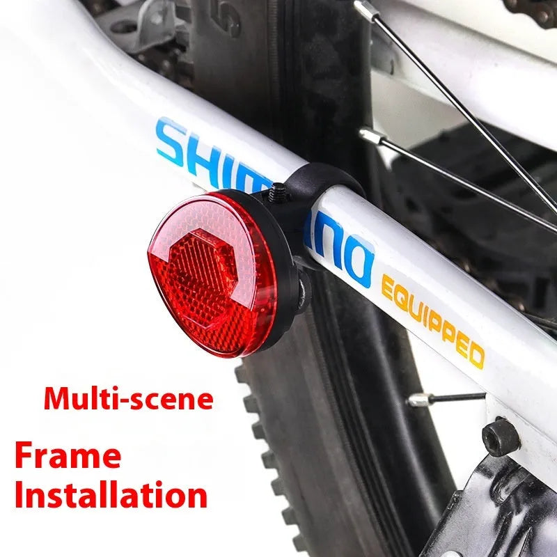 Red plastic anti-theft bicycle taillight bracket mounted on a bike seat post.