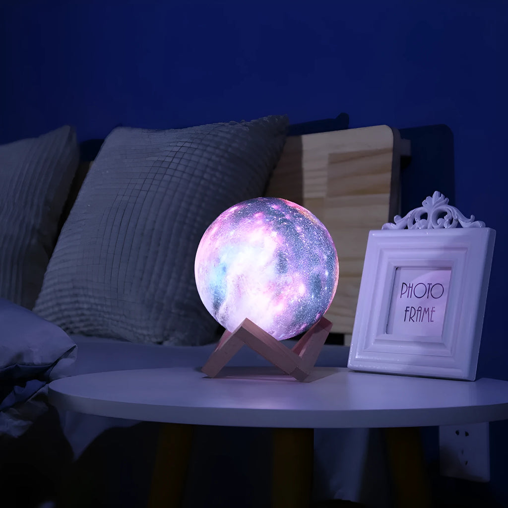 3D printed white moon lamp night light glowing on a surface next to its remote control.