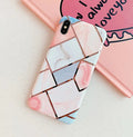 Flexible silicone gel mobile phone case for various iPhone models on a table.