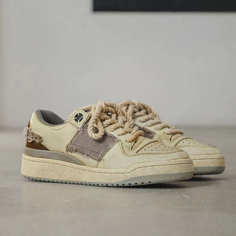 Beige low-top skateboard shoes with lace-up front and rubber soles