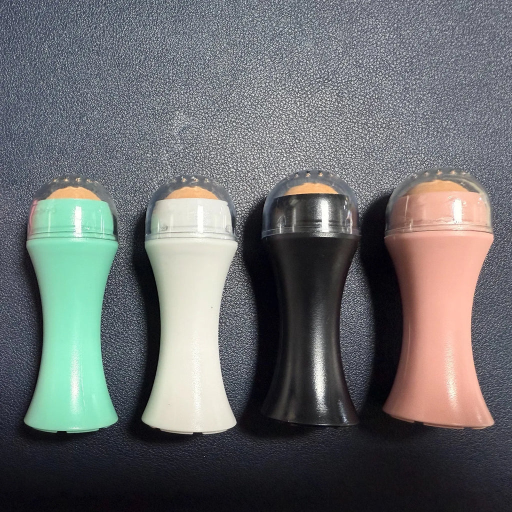 Volcanic stone portable oil absorbing facial roller in choice of colours on a white background.