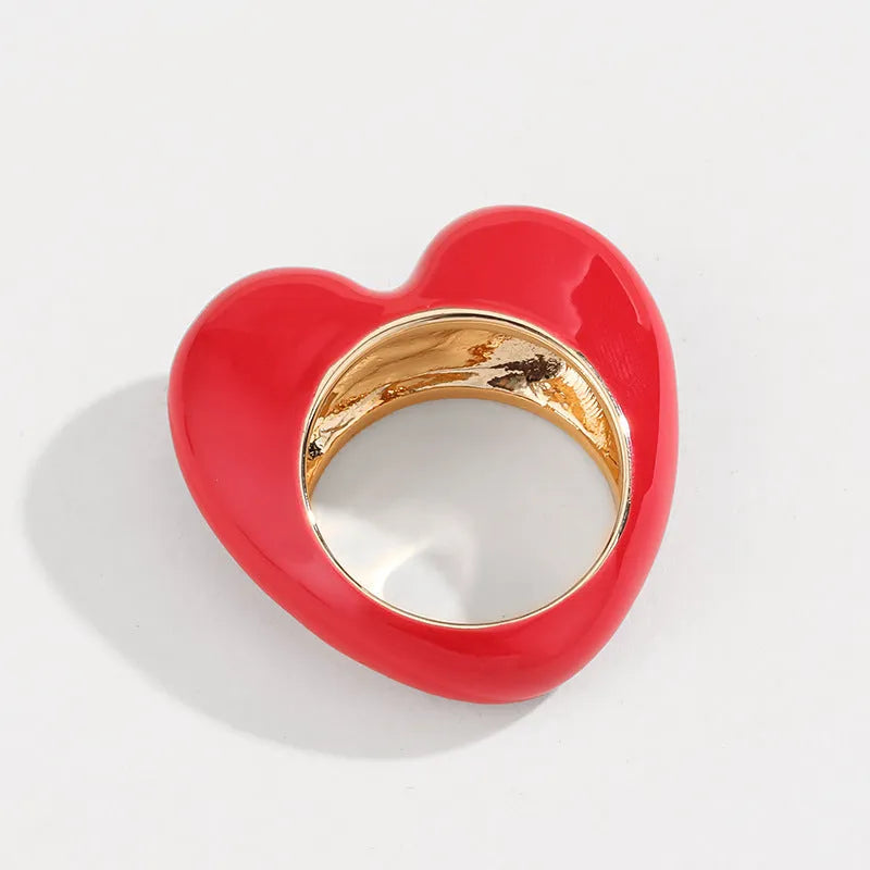 Colourful three-dimensional heart-shaped enamel ring made from zinc alloy, shown in red.