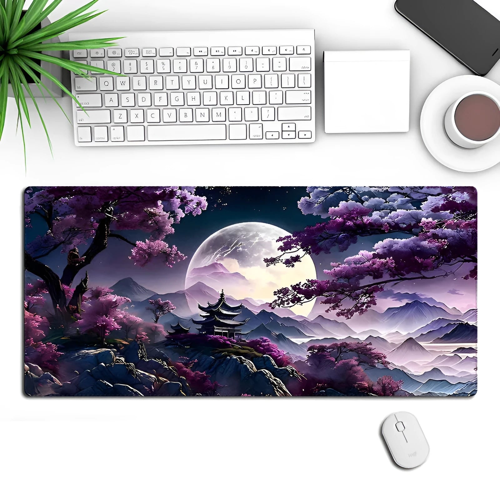 Large black gaming desk mat with stitched edges shown on a desk with keyboard and mouse.
