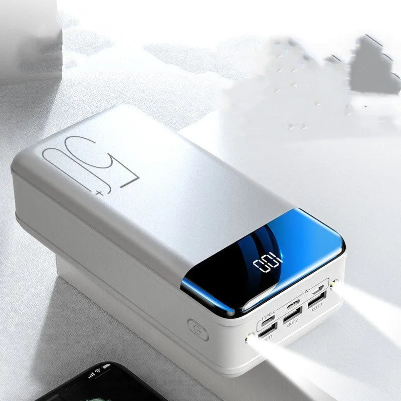 Black and white large 50000mAh power bank with three USB output ports on a plain background.
