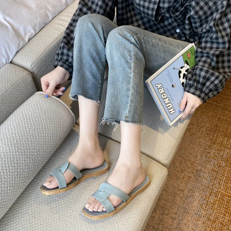 Women's cross strap PVC sandals in light blue, showing toe ring and non-slip sole.