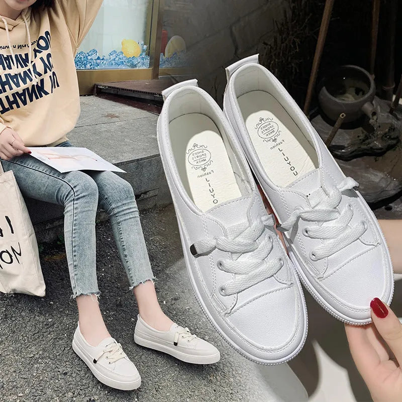 Women's casual lace-up shoes in white with round toe and rubber sole, side view
