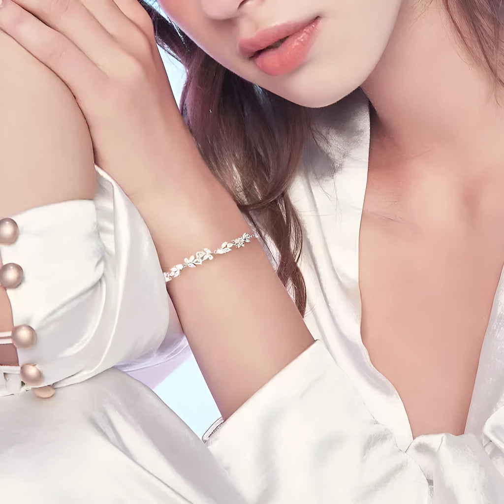 White copper wisteria flower bracelet with electroplated white gold finish featuring bow leaf and drop shapes