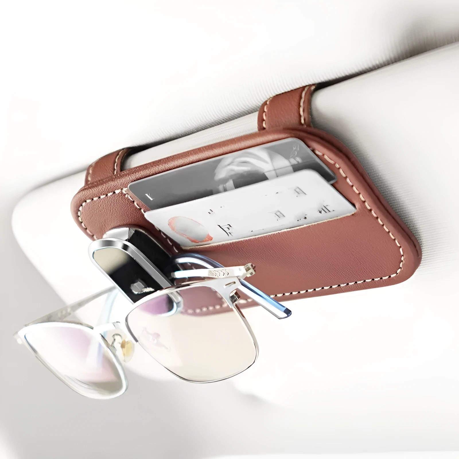 Beige leather car sun visor organiser holding cards and a pair of sunglasses.
