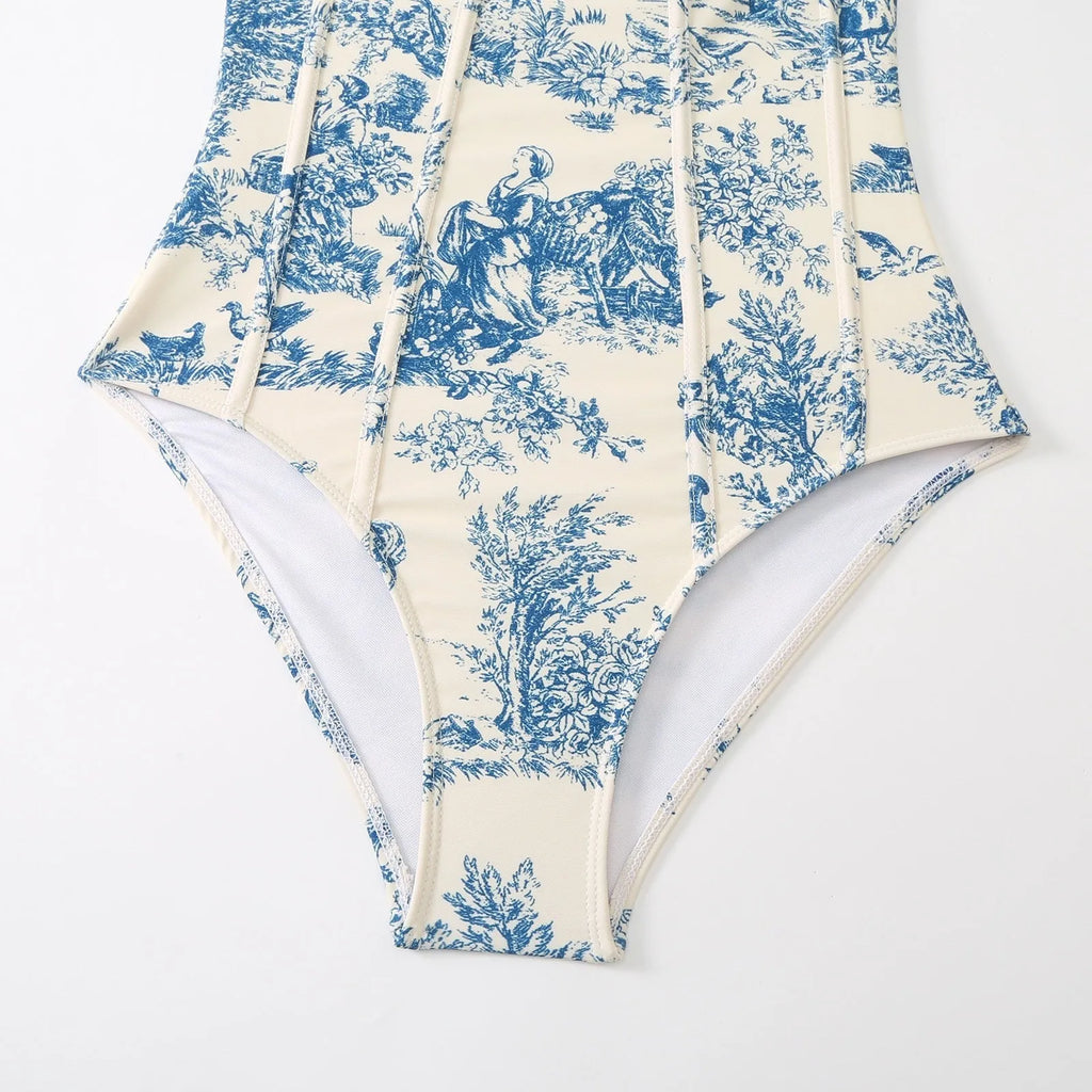 Blue women's one-piece polyester swimsuit with a matching gauze skirt laid flat.