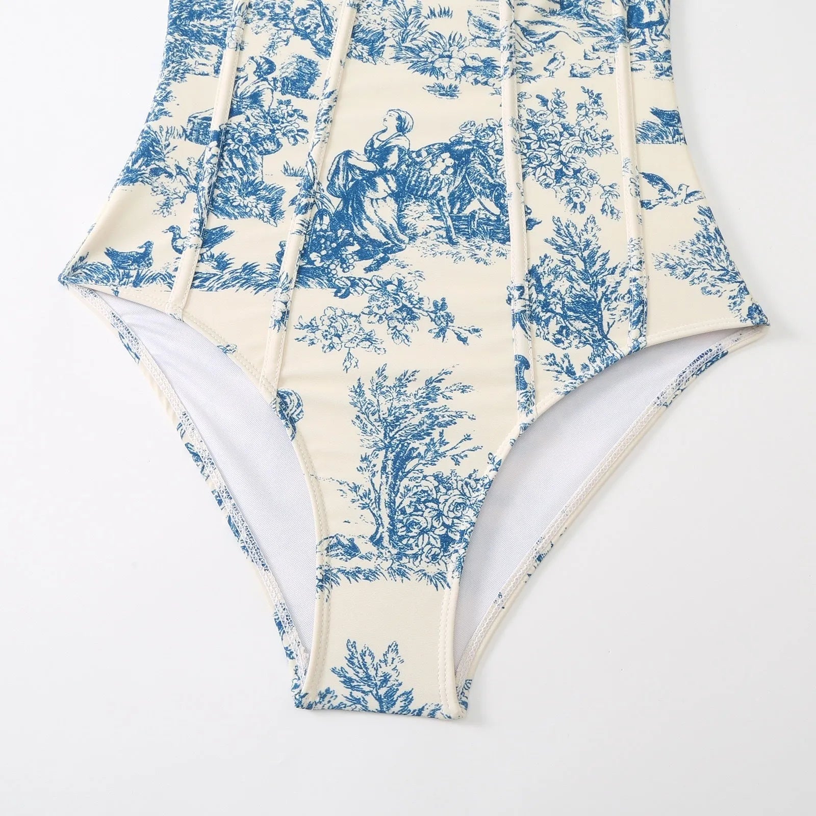 Blue women's one-piece polyester swimsuit with a matching gauze skirt laid flat.