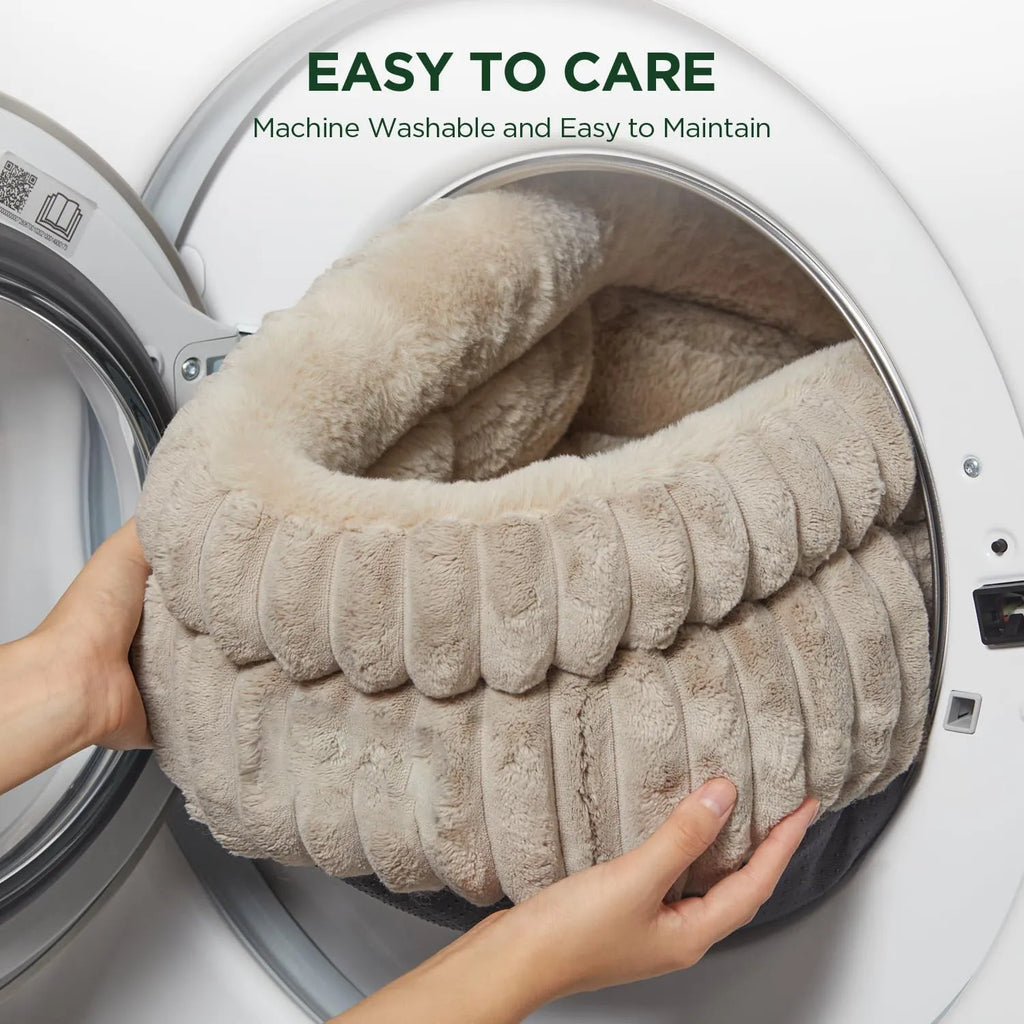 Washable round cat bed in beige with super soft plush faux fur and anti-slip bottom