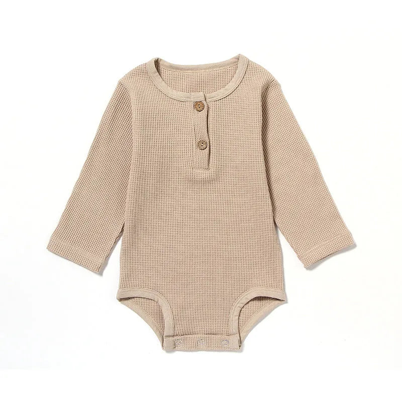 Baby wearing long sleeve waffle cotton romper with either cotton rope ties or button front closure in beige, khaki, green or blue