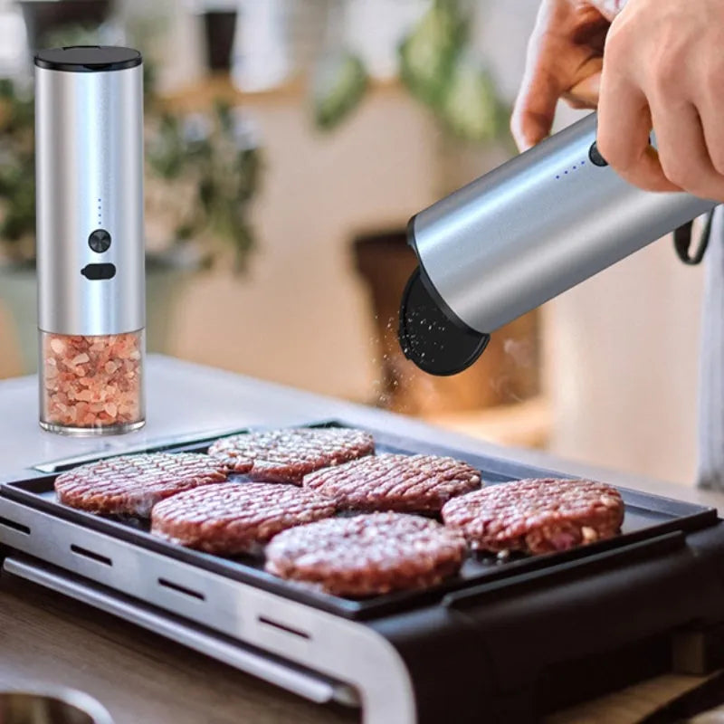 White and black electric salt and pepper grinders with USB charging ports and clear glass jars