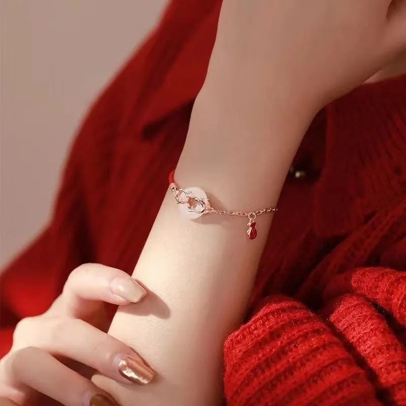 Japanese style festive koi bracelet with red rope, peace buckle, and electroplated finish for women