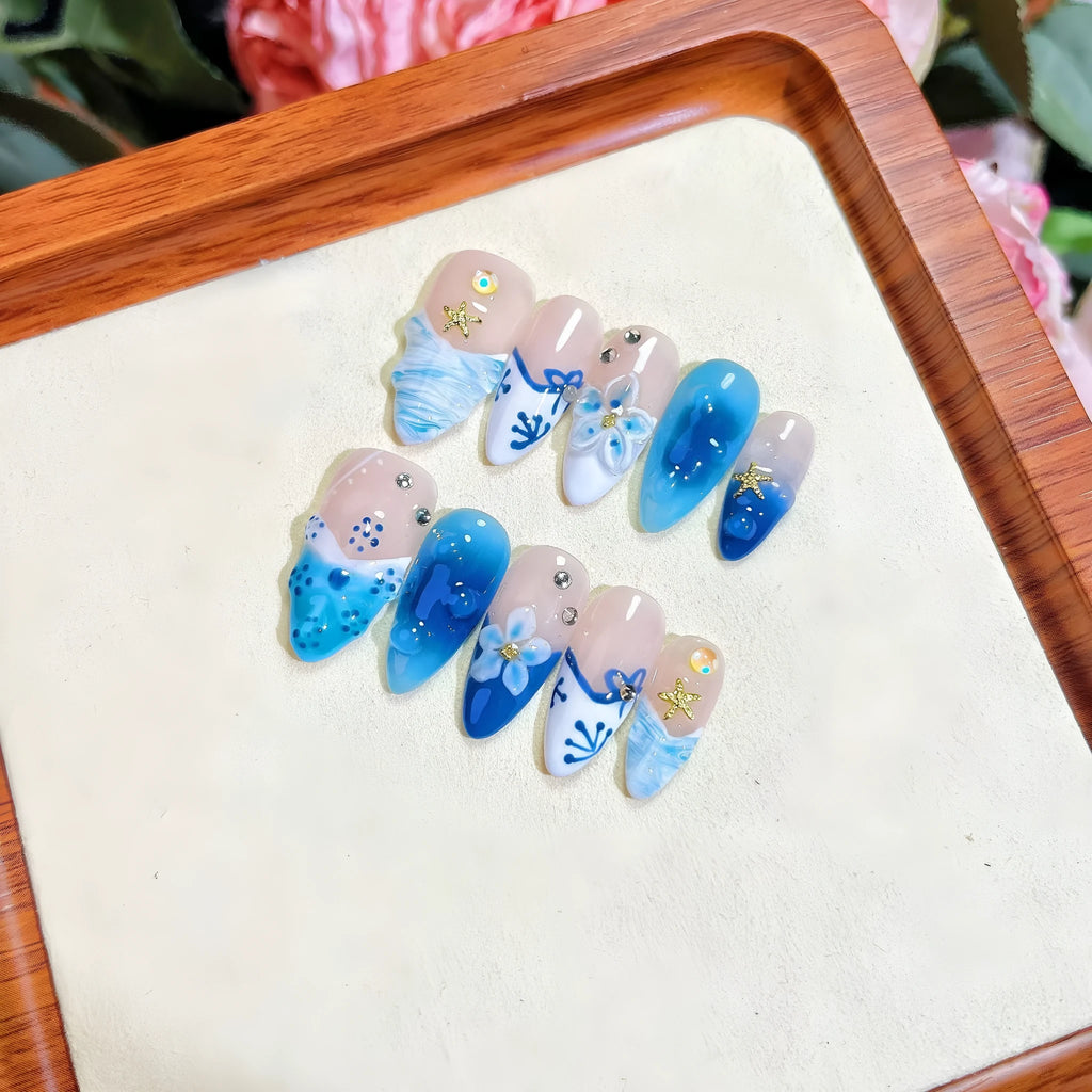 Blue false nails with hand-painted carved summer ice transparent design, shown in XS, S, M, L sizes.