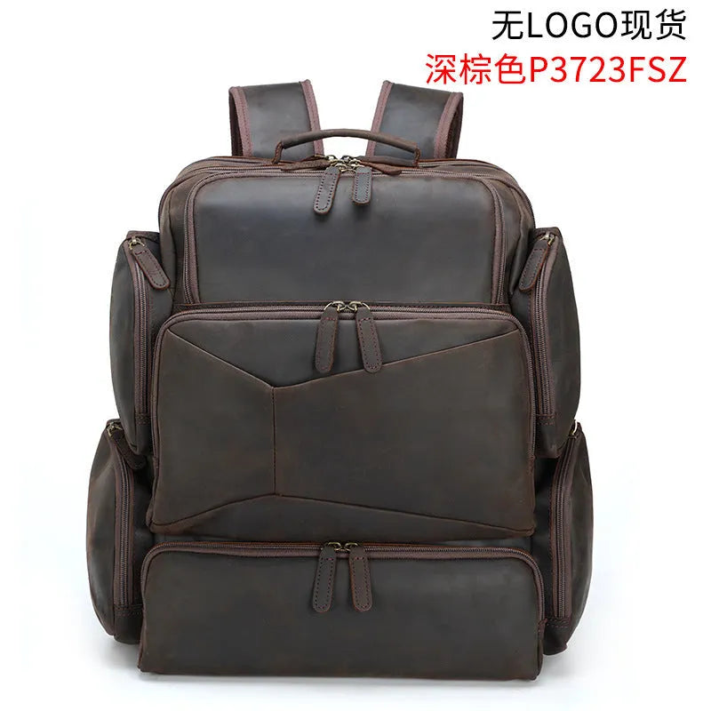Dark brown genuine leather men's backpack open to show 17-inch laptop compartment and internal organiser pockets.