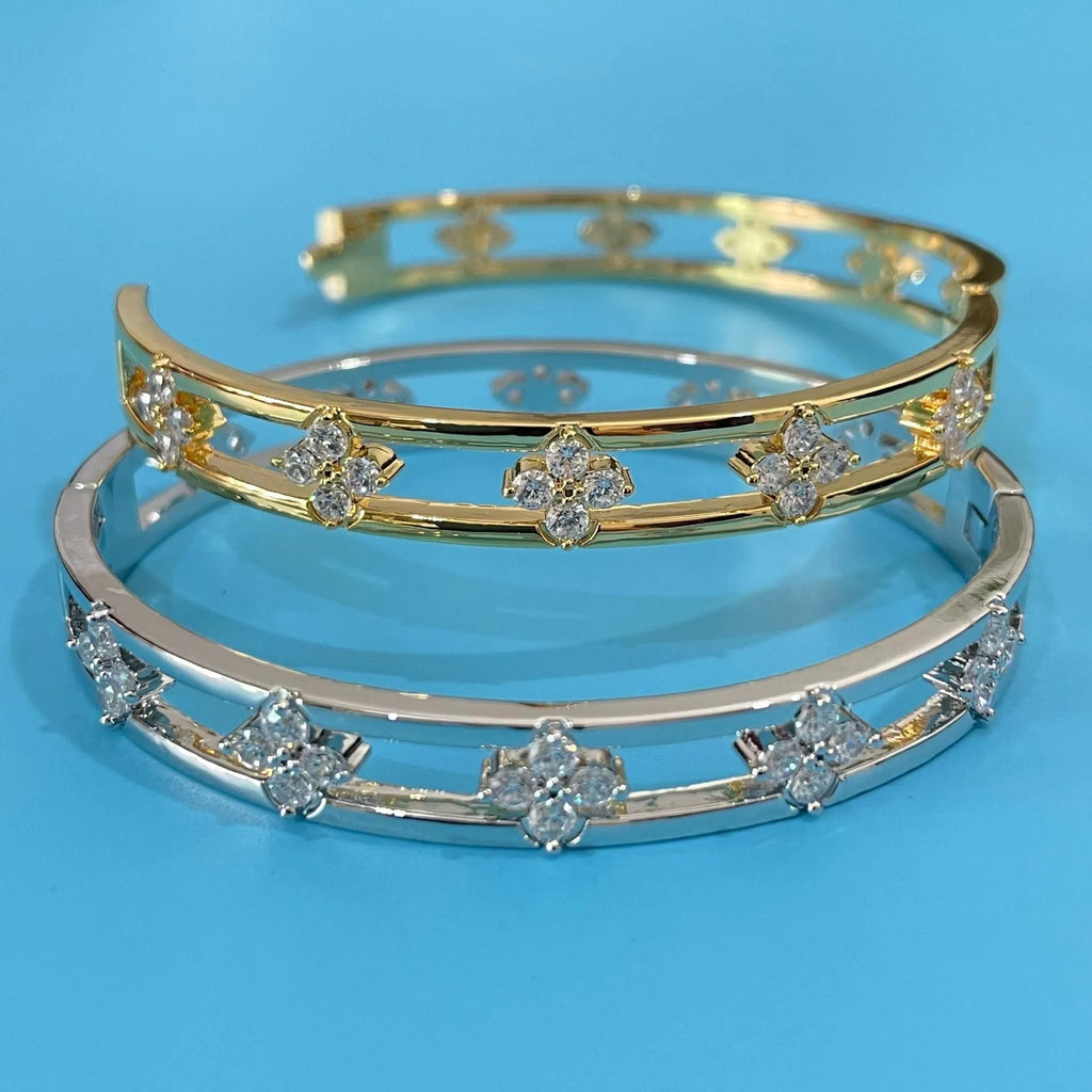 Gold and silver hollow women's bracelet with zircon four-leaf clover and grass petal charm.