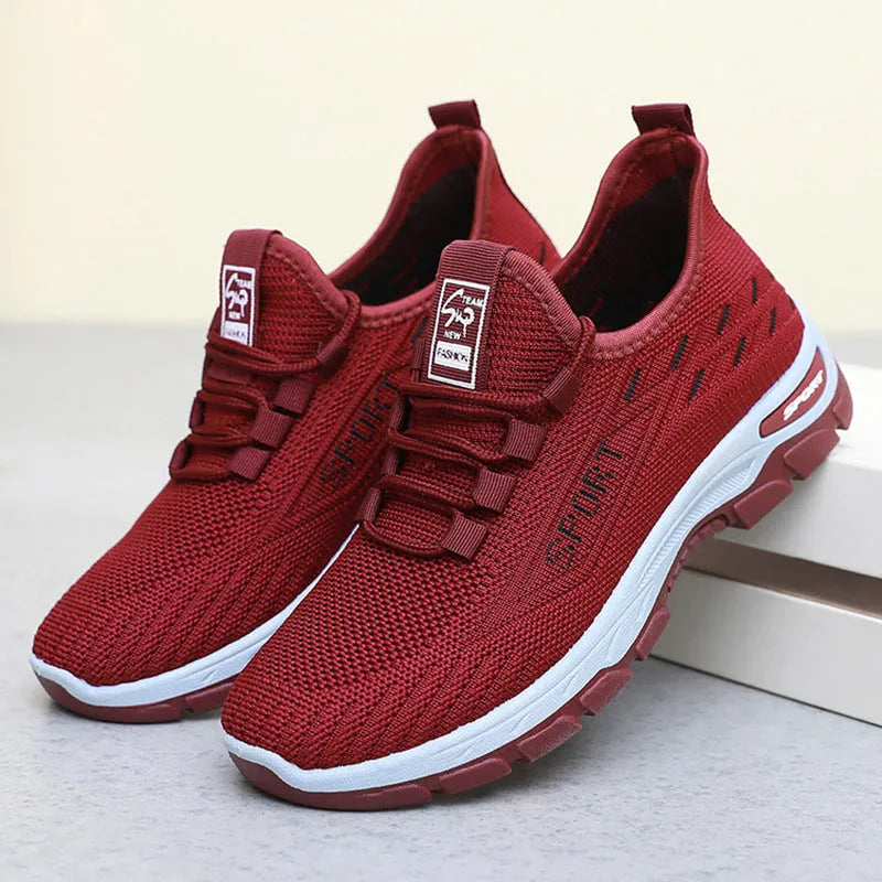 Men's and women's low-top casual sneakers with soft PVC sole in black, brown, grey, light purple, and red.