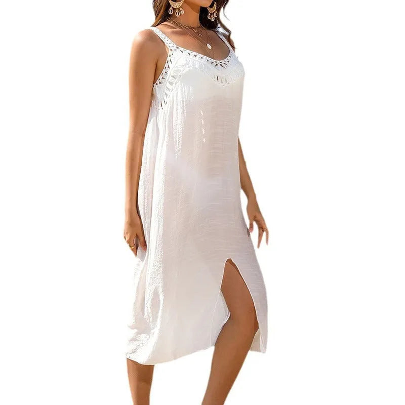 White crochet beach dress with hollow weave pattern, suspender straps, and bottom slit design