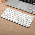 Compact 78-key Bluetooth wireless keyboard in silver white or black with USB charging interface