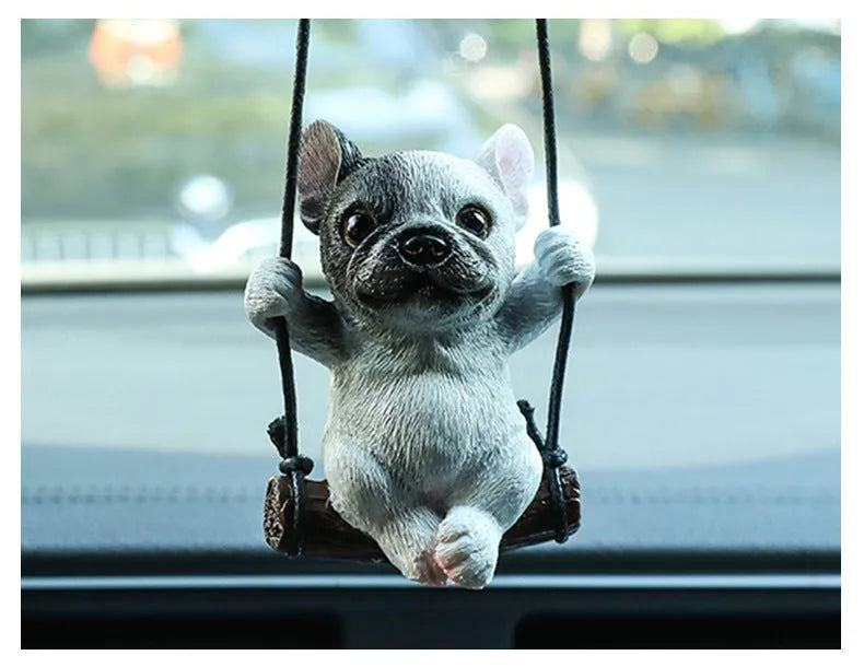 Small resin bulldog cartoon pendant for hanging on a car rearview mirror.