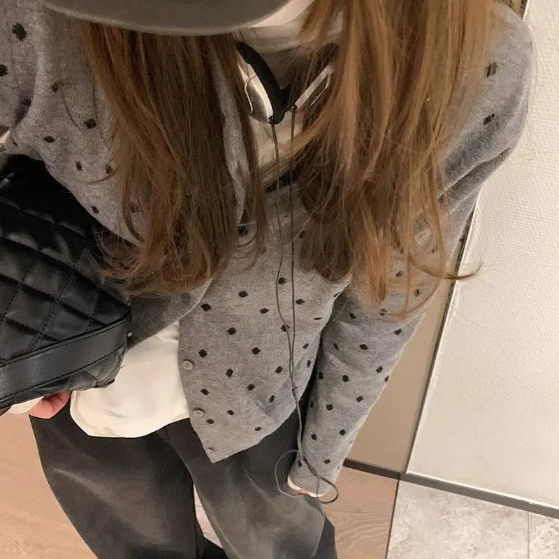 Women's grey dot pattern knitted cardigan with crochet flower detail, long sleeves, loose fit.
