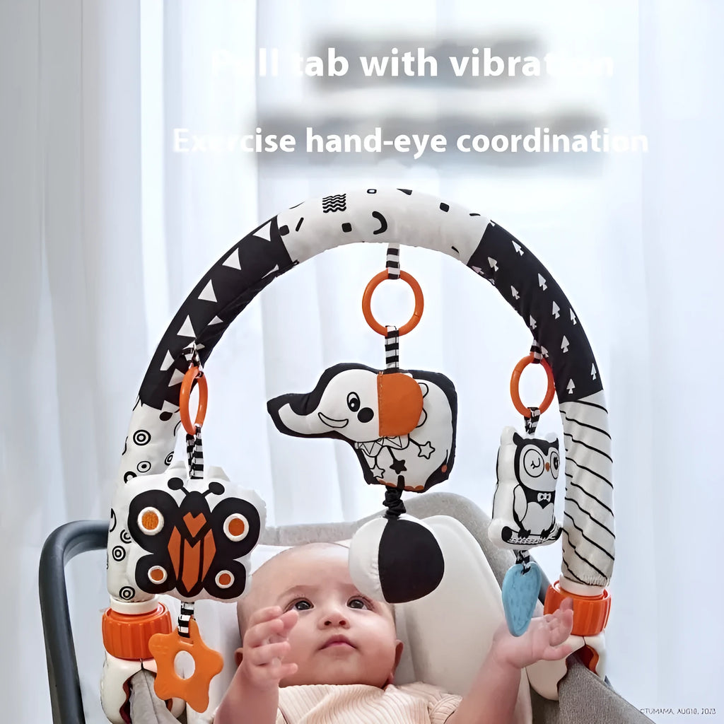 Baby lathe clip hanging plush toy in black and white, with pull vibration teether and BB call, attached to a cot side