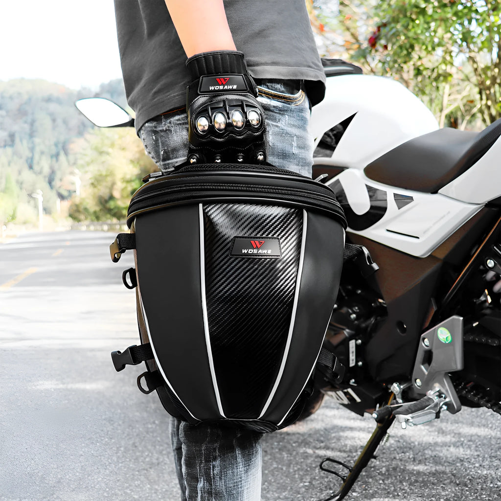 Black motorcycle seat bag with reflective strips, shown with carrying strap.