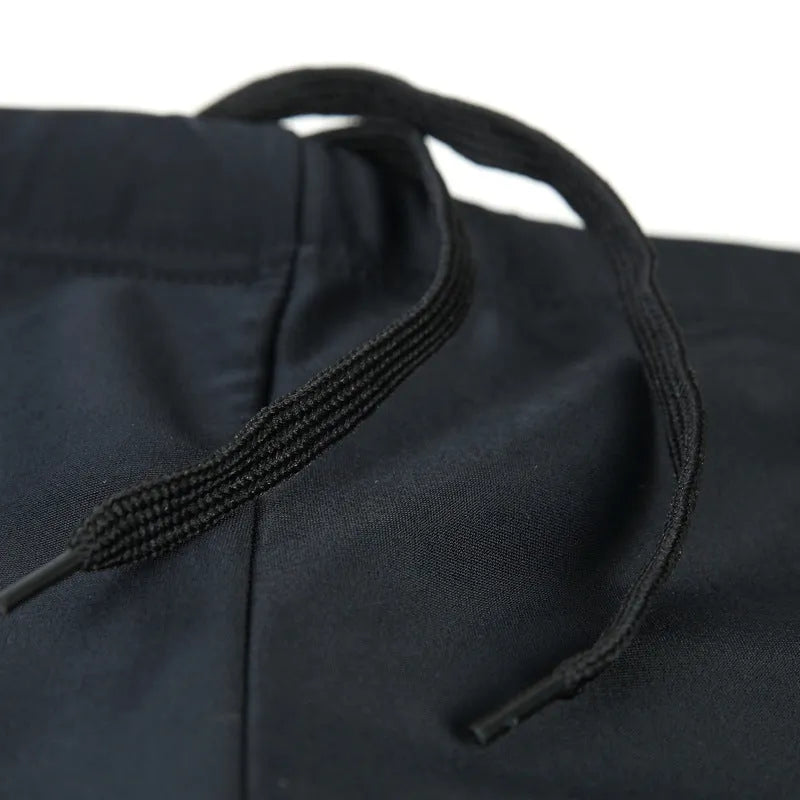 Men's plus-size blue fire pattern boxer swim trunks laid flat, with matching swimming cap.
