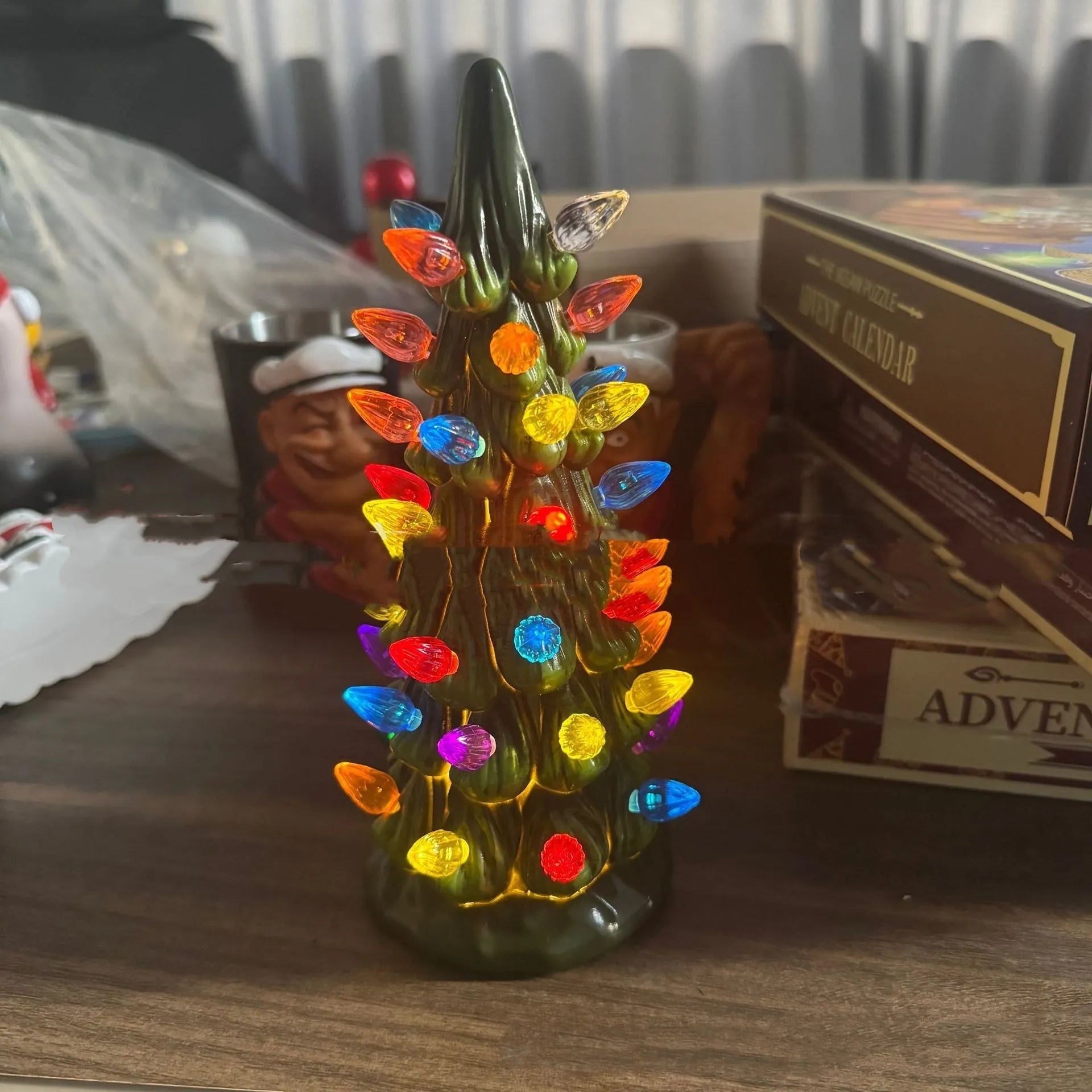 A European-style resin Christmas tree ornament with integrated coloured or warm LED lights, shown in 20cm, 25cm, and 30cm sizes.