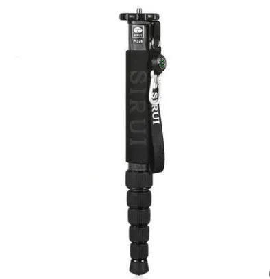 Black carbon fibre telescopic camera monopod fully extended next to an SLR camera