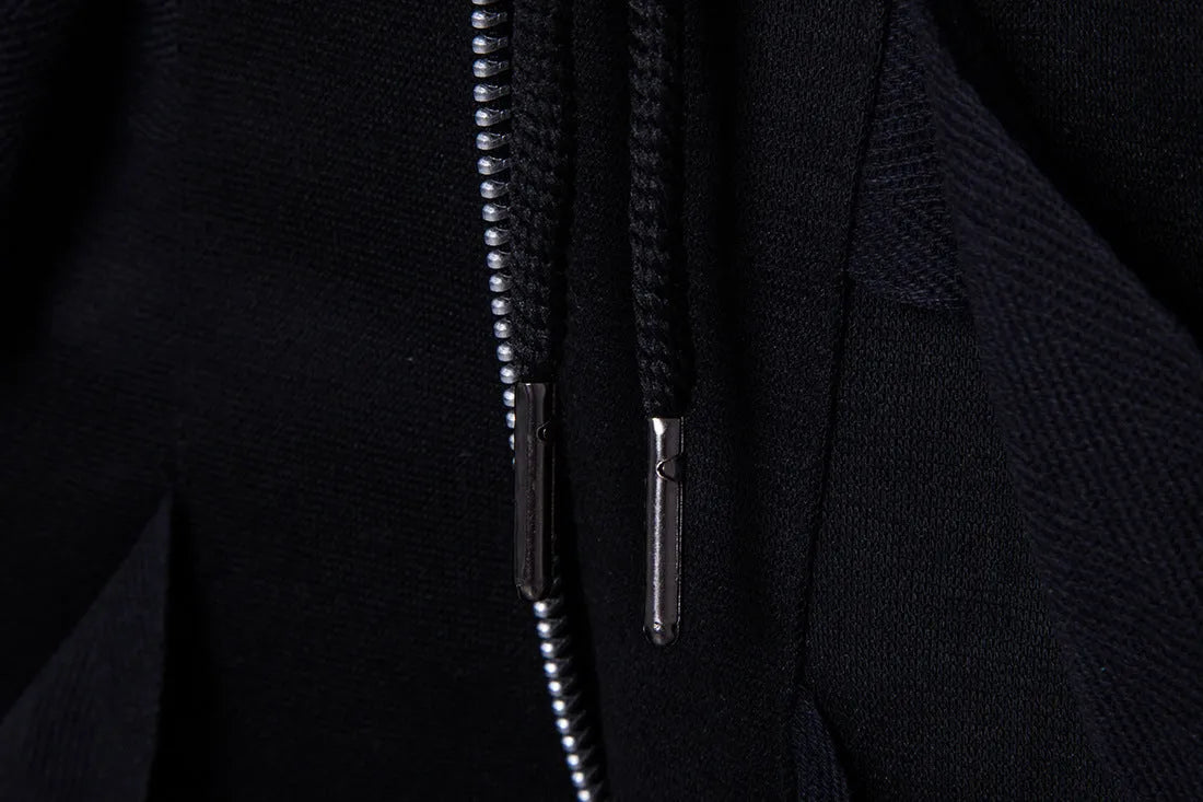 Men's black low crotch cross trousers with tapered cone leg and small hem on a plain background