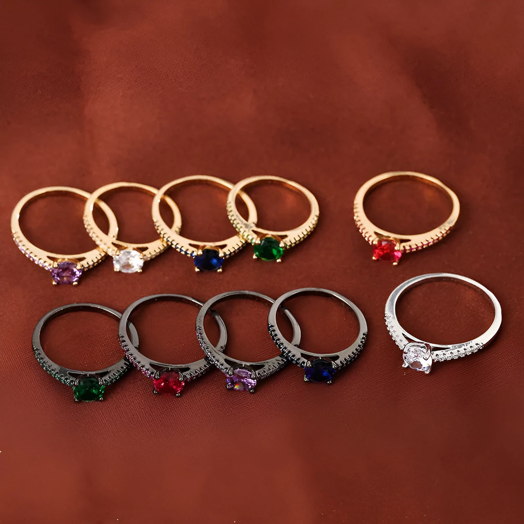 Hexagonal geometric zircon ring in copper with an electroplated gun black purple finish on a finger.