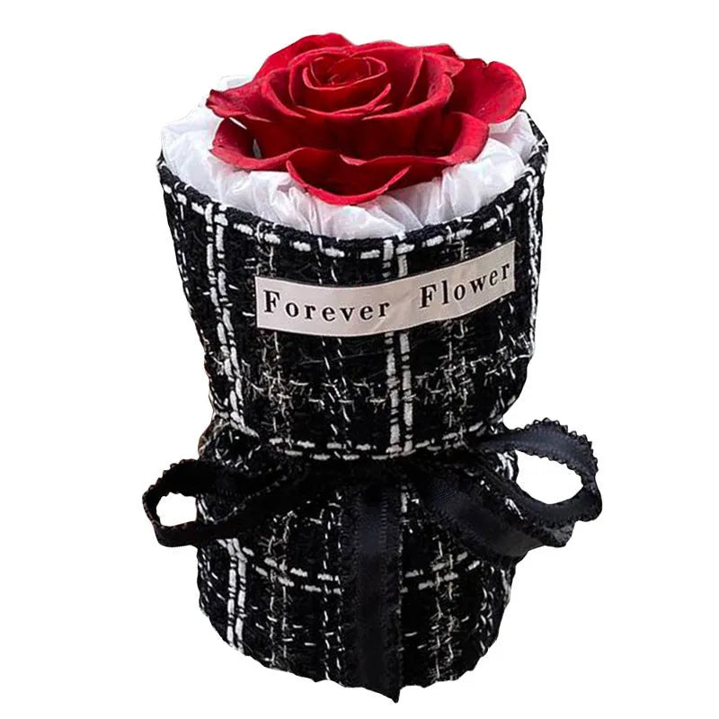 Dried flower eternal life bouquet in classic flowerpot style, red colour variant, on a tabletop