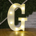 White plastic LED marquee letter sign with warm white glow, 22cm tall