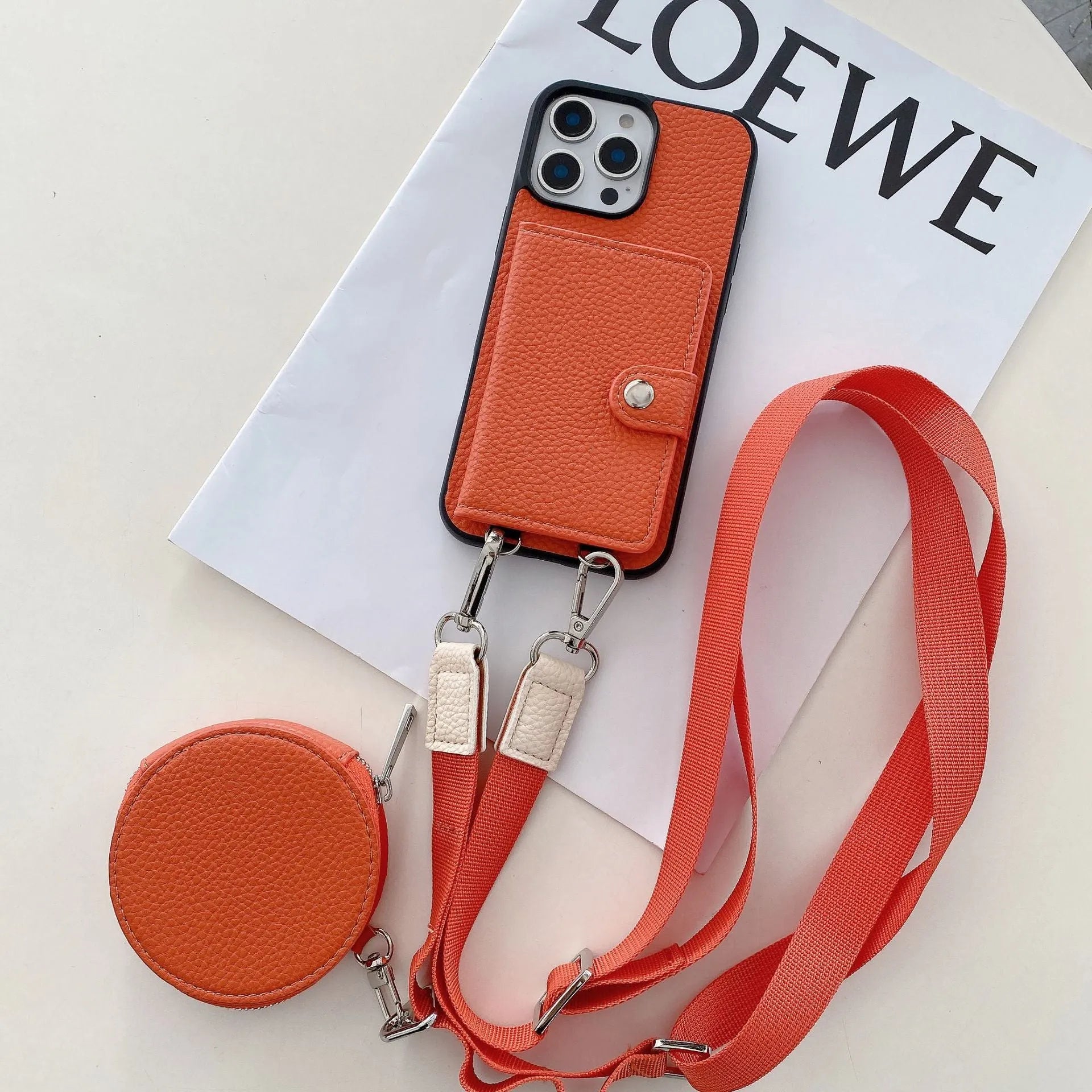 Black PC leather phone case with card slot and attached lanyard for iPhone, shown alongside credit cards.