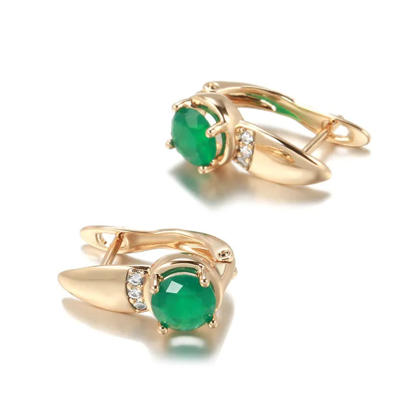 Rose gold plated copper stud earrings with emerald green zircon stone in U-shaped retro design on white background