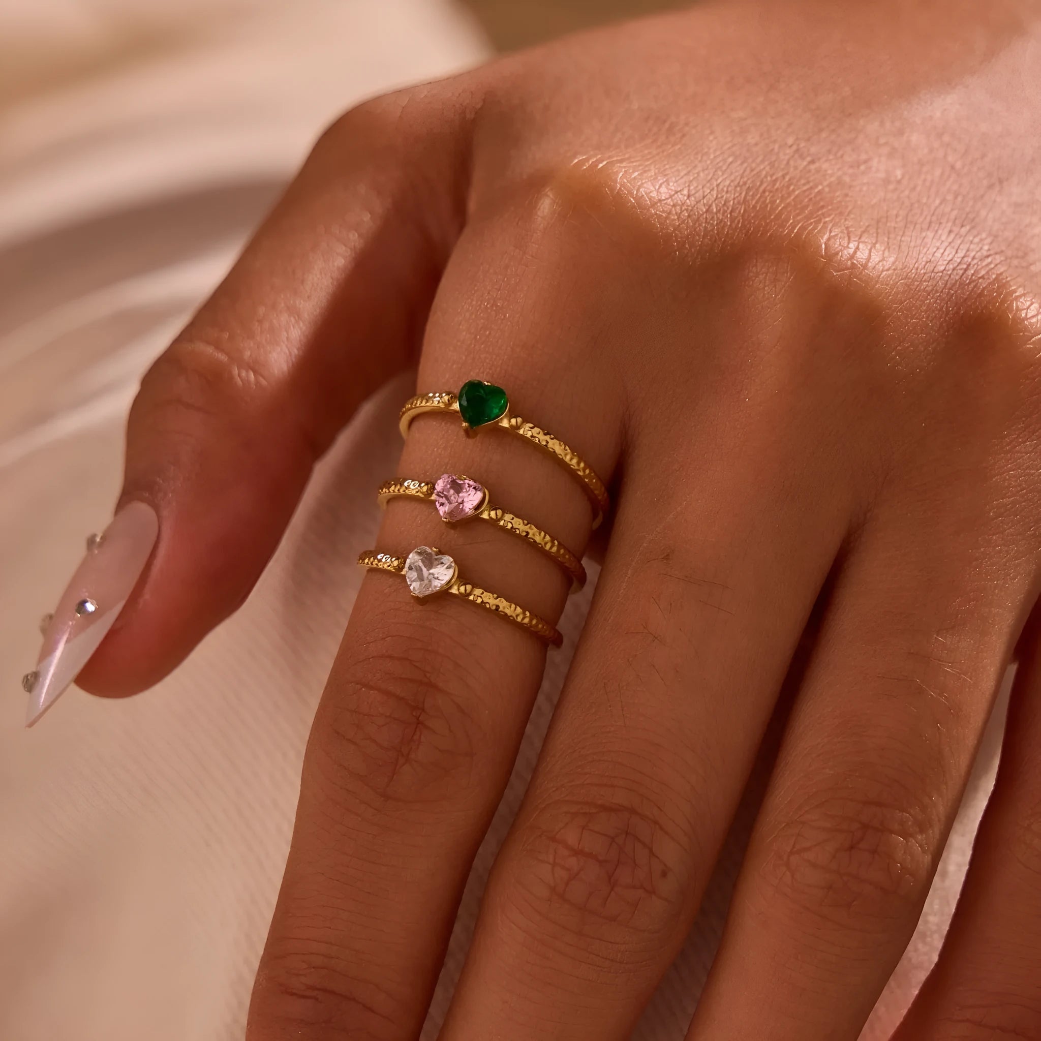 Open-ended stainless steel ring with a geometric design and a heart-shaped zircon inlay.