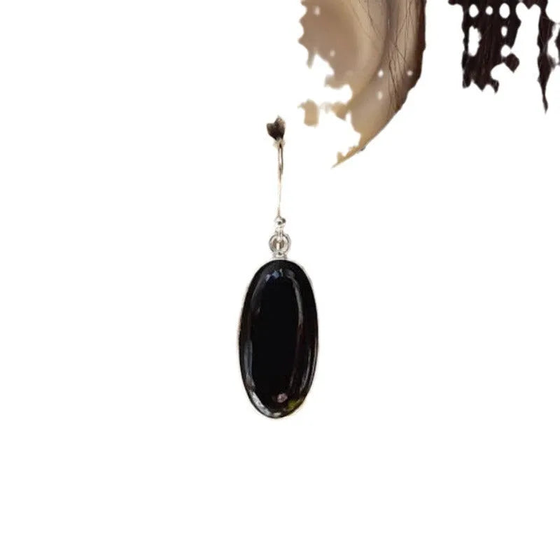 A pair of women's geometric earrings with a black agate oval pendant on alloy settings.