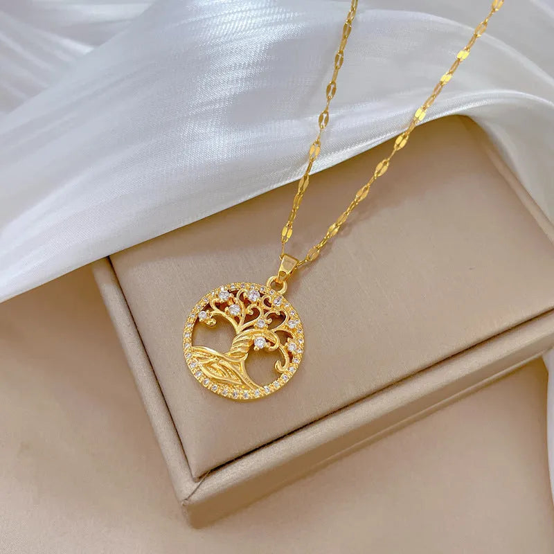 Gold-plated necklace with a white mother of pearl cross pendant and sparkling rhinestone details on a linked chain.