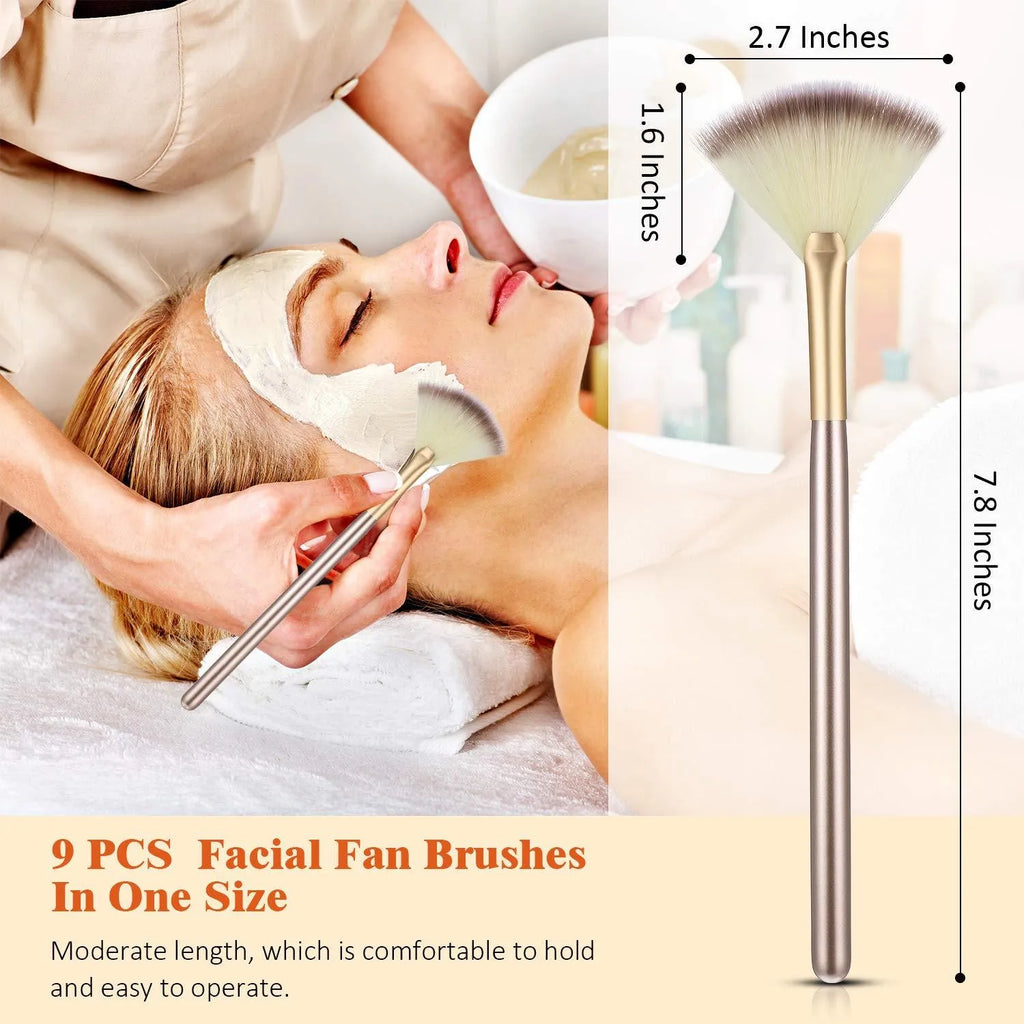 Set of 10 champagne-coloured facial fan brushes with wooden handles on a white background.