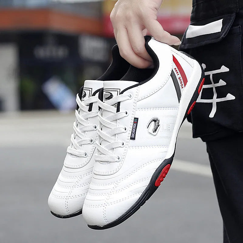Men's casual sneakers with white space leather upper, round toe, and flat heel on a plain background