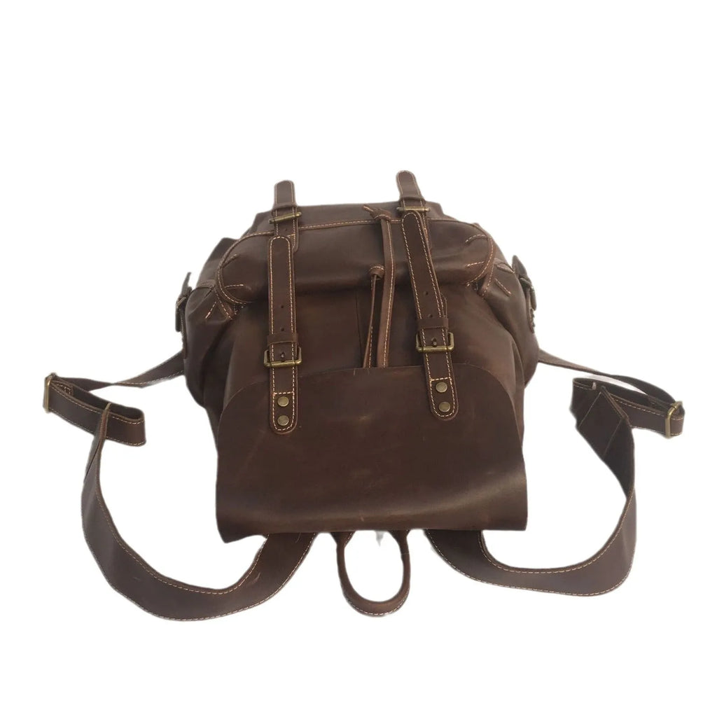 Brown leather men's backpack with shoulder straps showing cowhide leather texture